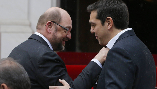 European Parliament President Schulz points out that Greek Prime Minister Tsipras is not wearing a tie outside the Greek Premier's office in Athens