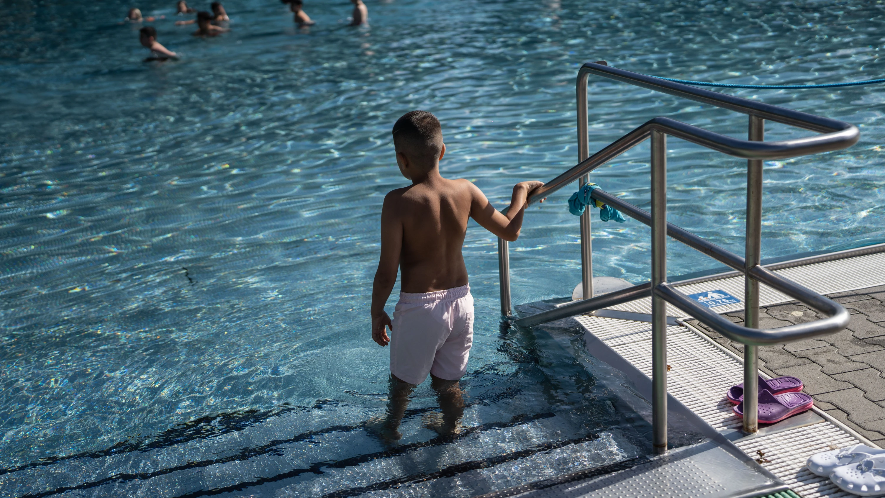 Vorsichtig: Ein Junge im Freibad Hausen in Frankfurt tastet sich ins Wasser vor. - Frank Rumpenhorst