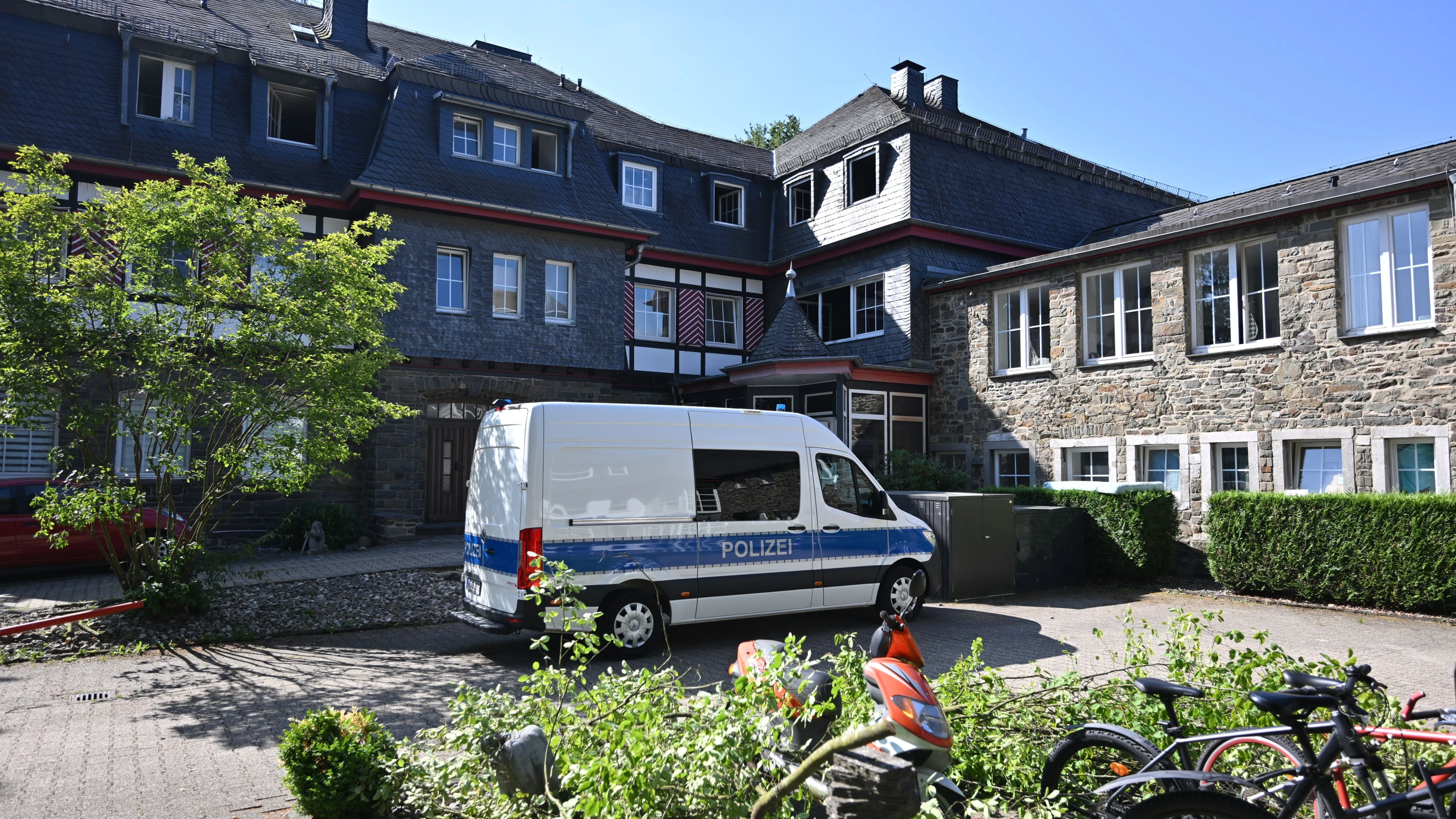 Monschau: Ein Polizeiauto steht am Mittwoch vor dem Gebäudekomplex, in dem es gebrannt hat. - dpa