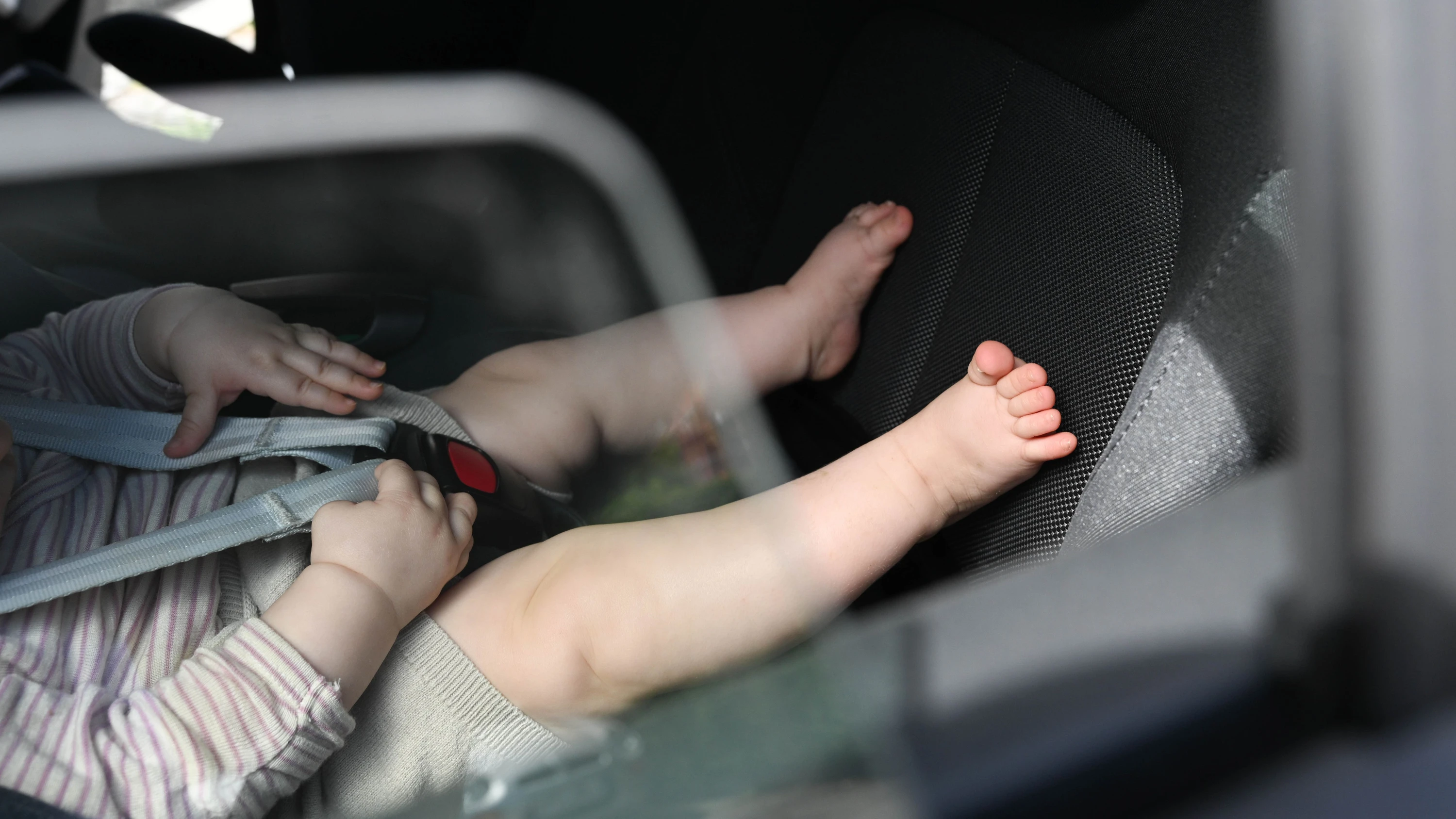 Stuttgart: Ein Baby sitzt an einem sonnigen Tag im Auto (Symbolbild). - dpa