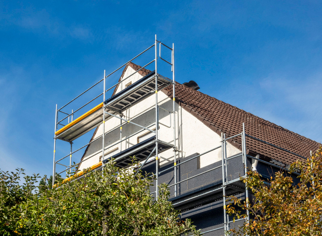 Germany, Bavaria, Augsburg, Scaffolding and thermal insulation on detached house