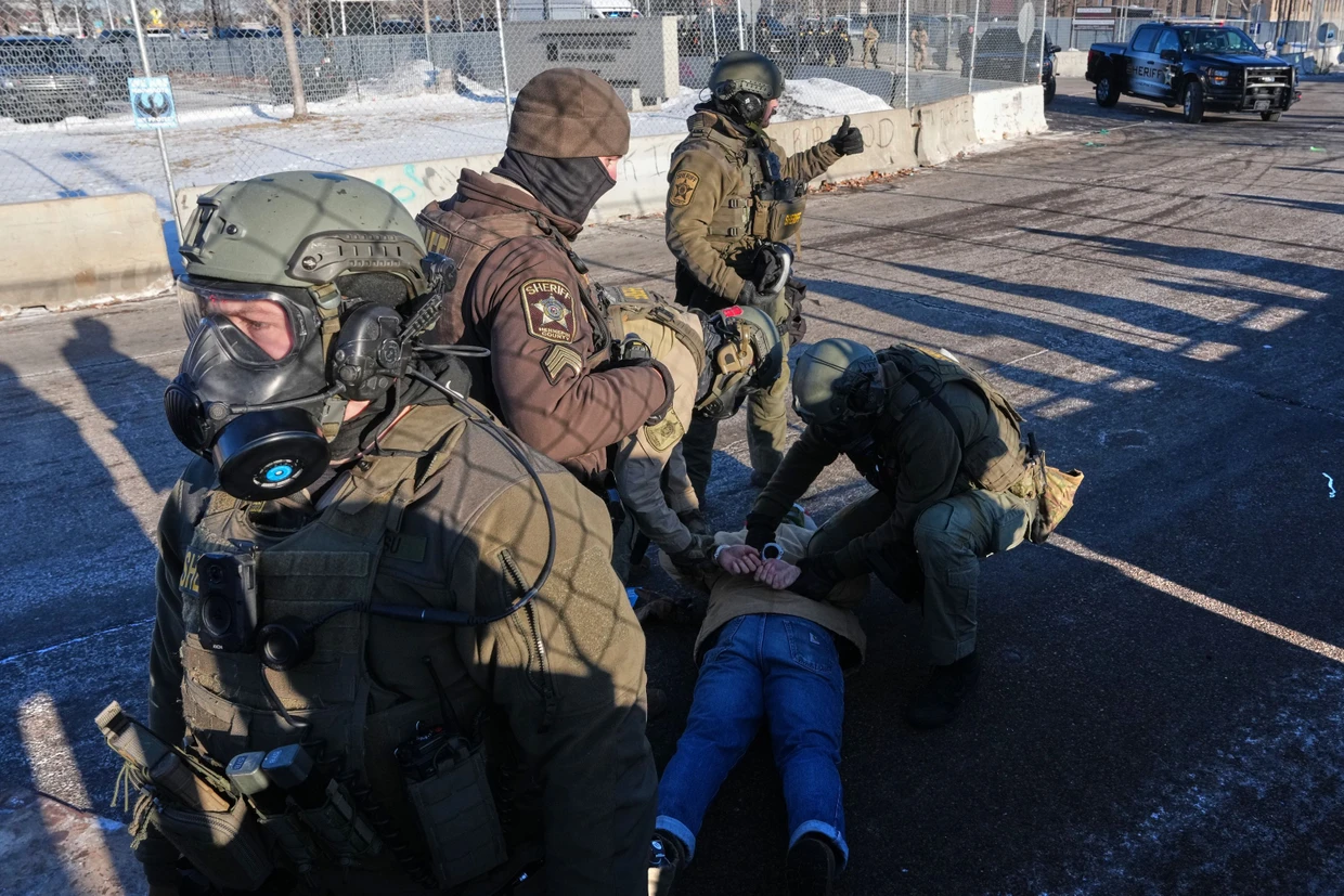 Beamte der US-Einwanderungsbehörde ICE halten eine Person während einer Demonstration fest.