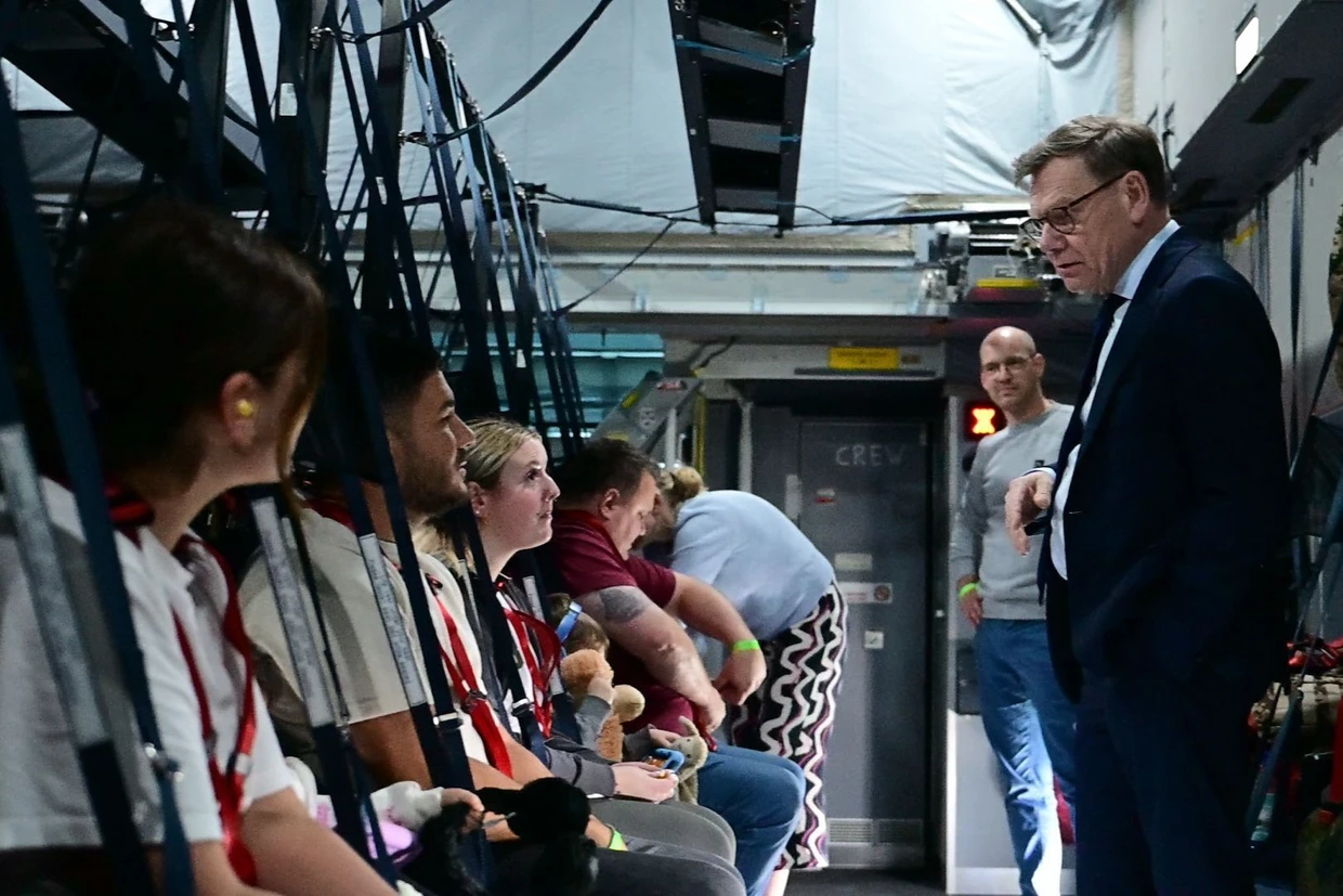 Wadephul spricht am Flughafen Doha in einem A400M mit deutschen Reisenden, die in Qatar gestrandet waren und nun mit dem Flugzeug nach Riad fliegen.