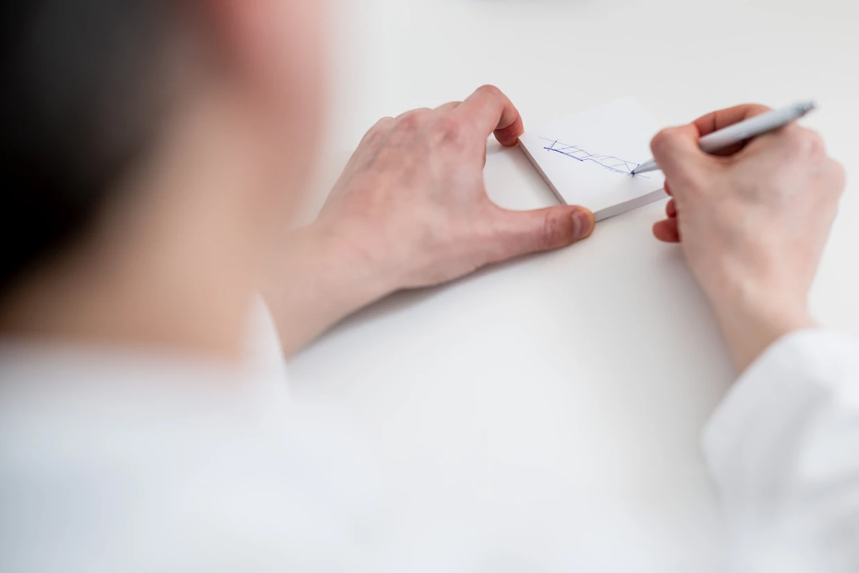 Zeichner: Tobias Sossalla erläutert mit Kuli auf Papier eine Engstelle in einer Ader.