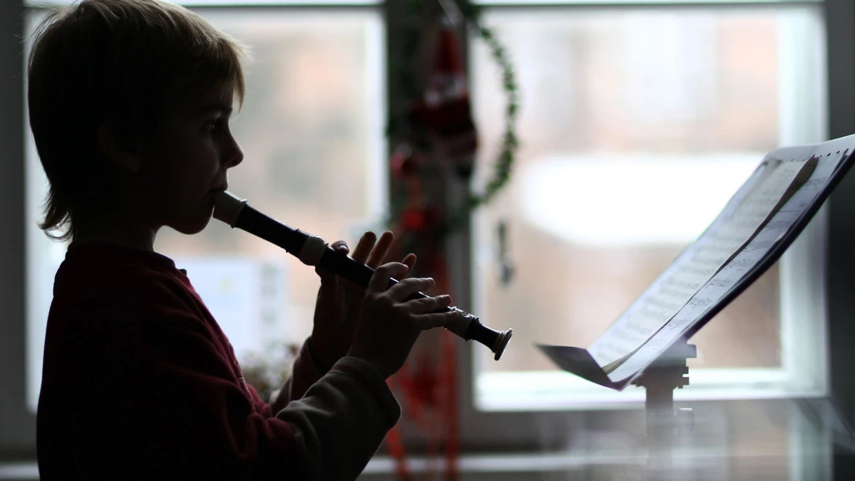 Ein Musikschüler spielt auf der Blockflöte.