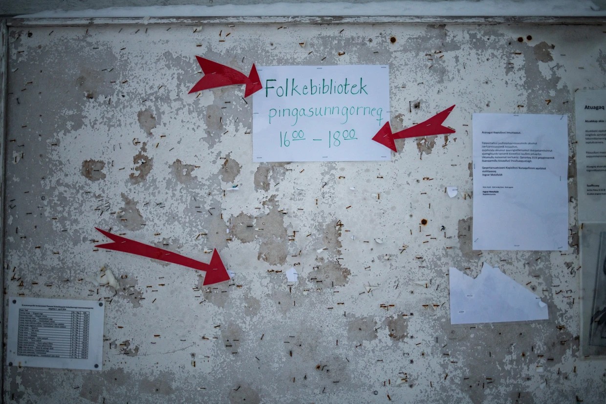 Am Aushang stehen die Öffnungszeiten der Bibliothek.