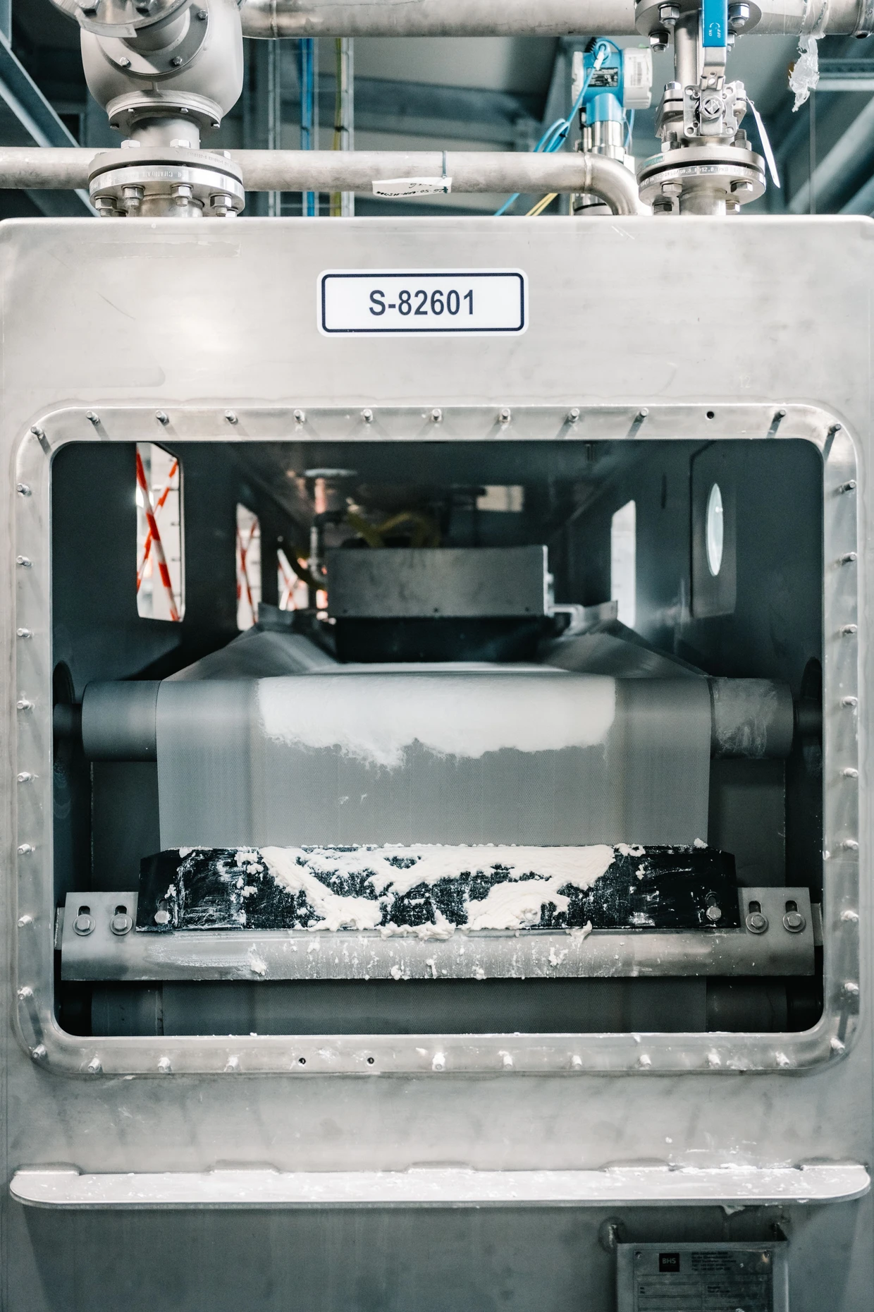 Fast fertig: Auf diesem Förderband liegt bereits das ersehnte BHET, allerdings noch in pastöser Form. Nach der Trocknung ist es weißes Pulver.