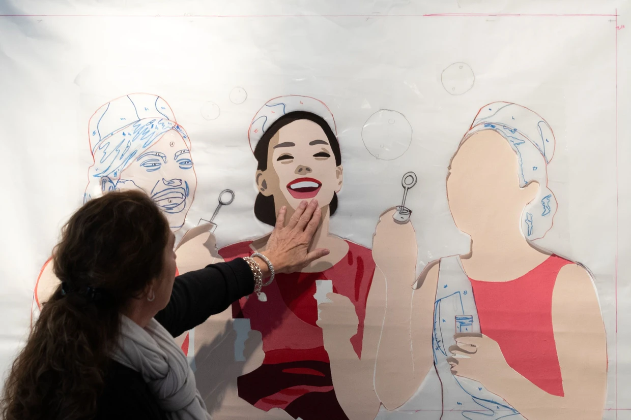 An einem unvollendeten Werk kann man sehen, wie die Bilder aus Stoff, Leinwand und Schnittmusterpapier entstehen.