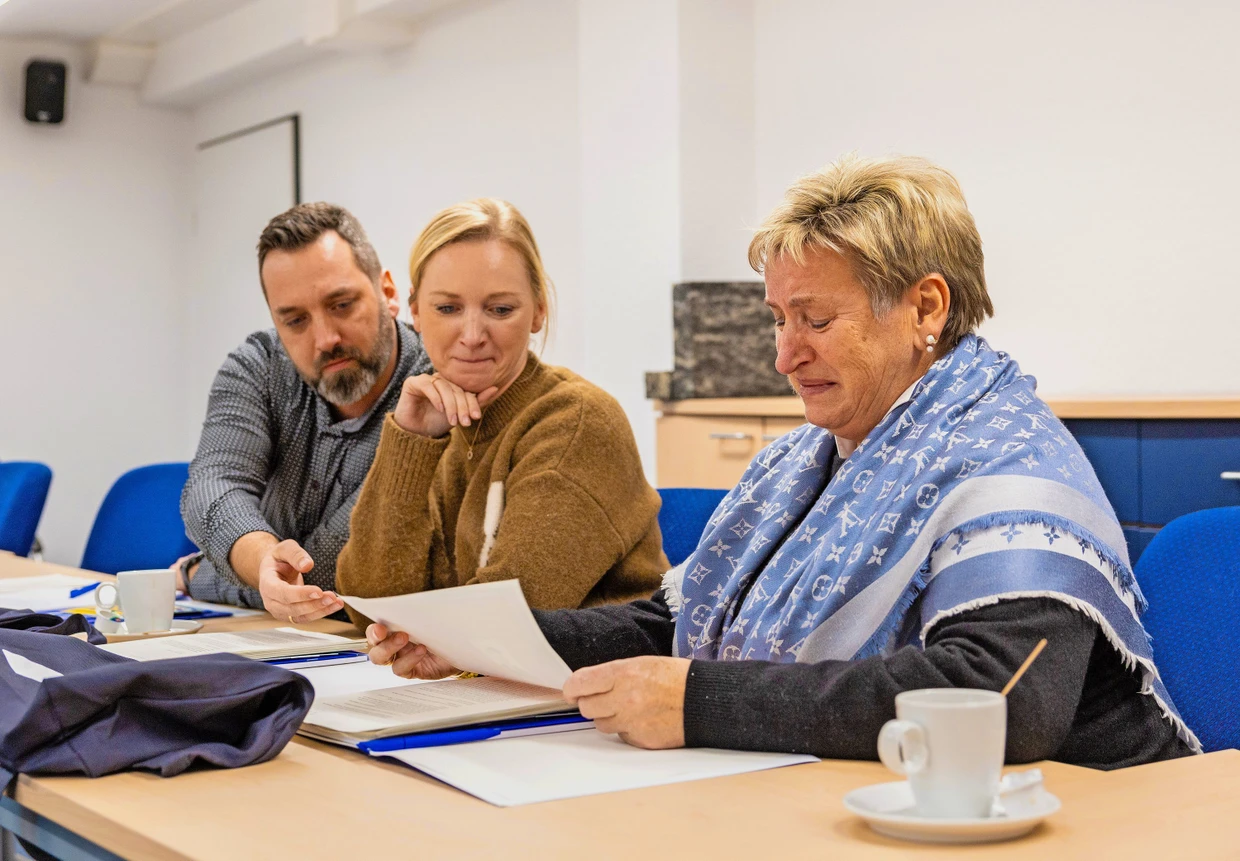 Markus Szczypta (Großneffe), Martha Gödde (Großnichte) und Halina Szczypta (Nichte, von links), sehen sich in den Arolsen Archives Dokumente zu ihrem Verwandten Mieczysław Kopyto an.