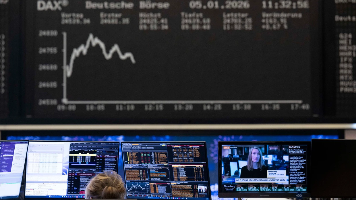 Stock traders follow price developments on their monitors at the Frankfurt Stock Exchange.