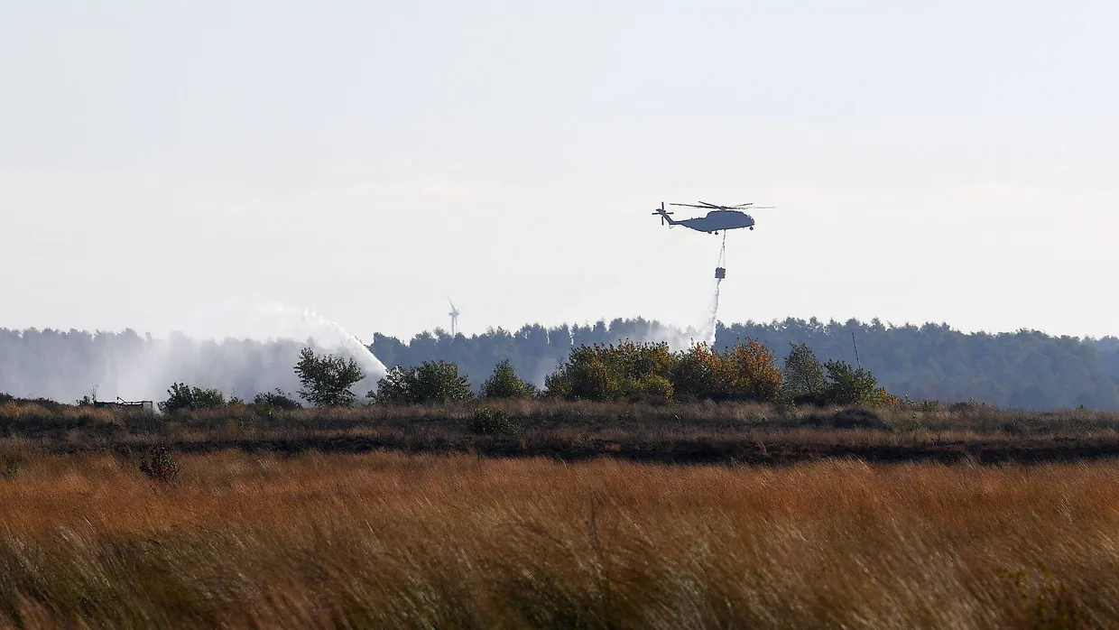 Ein Transporthubschrauber CH-53 der Bundeswehr gibt beim Moorbrand auf dem Gelände der Wehrtechnischen Dienststelle 91 (WTD 91) in Meppen Wasser ab. (Archivfoto)