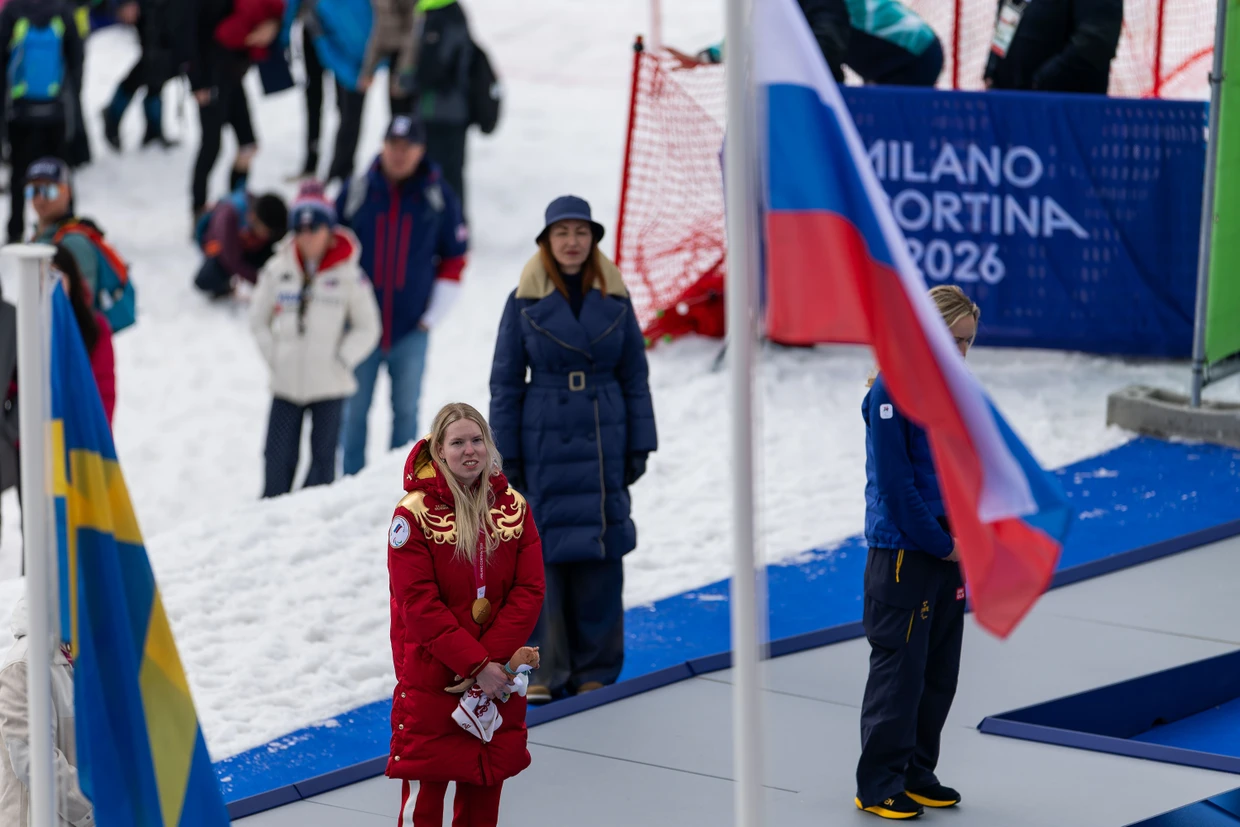 The Russian national flag is hoisted during the award ceremony for Warwara Voronchikhina.