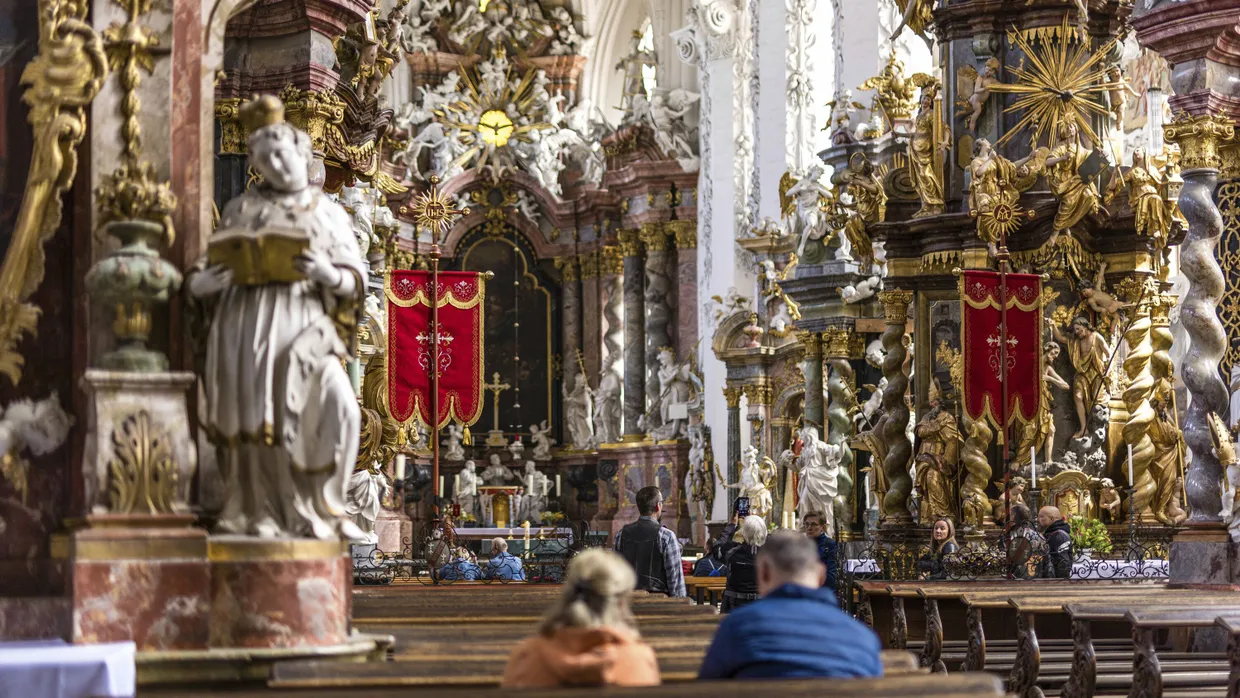 Menschen besuchen am Himmelfahrtstag die Katholische Stiftskirche St. Marien im Kloster Neuzelle.
