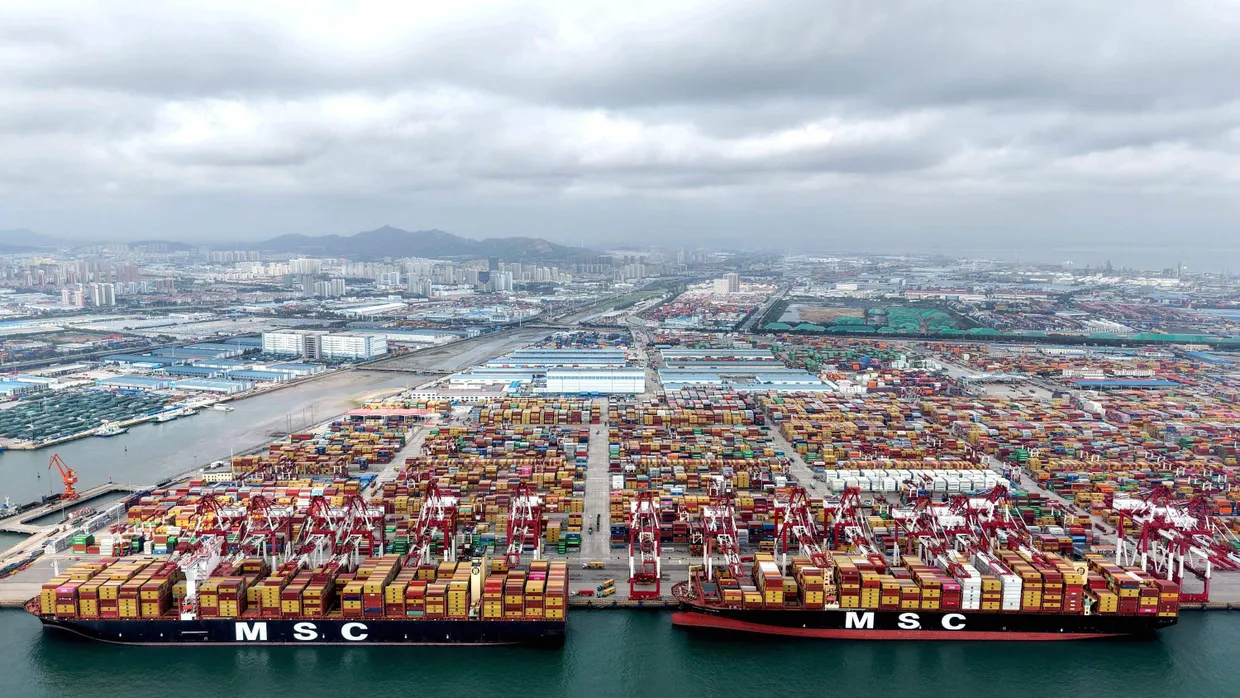 Container lagern im Hafen von Qingdao und werden verladen.