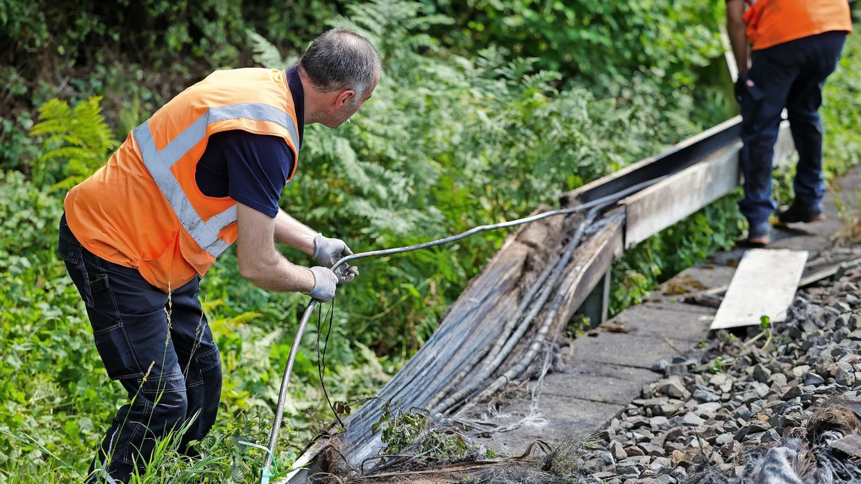 Railway employees in Düsseldorf in July after a cable fire set by left-wing extremists