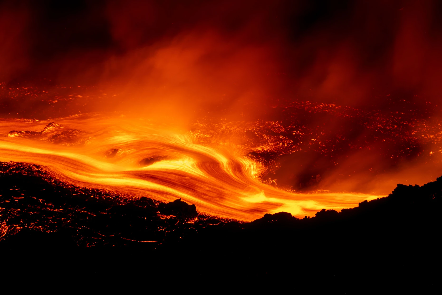 Lava flows down the slopes of Mount Etna.