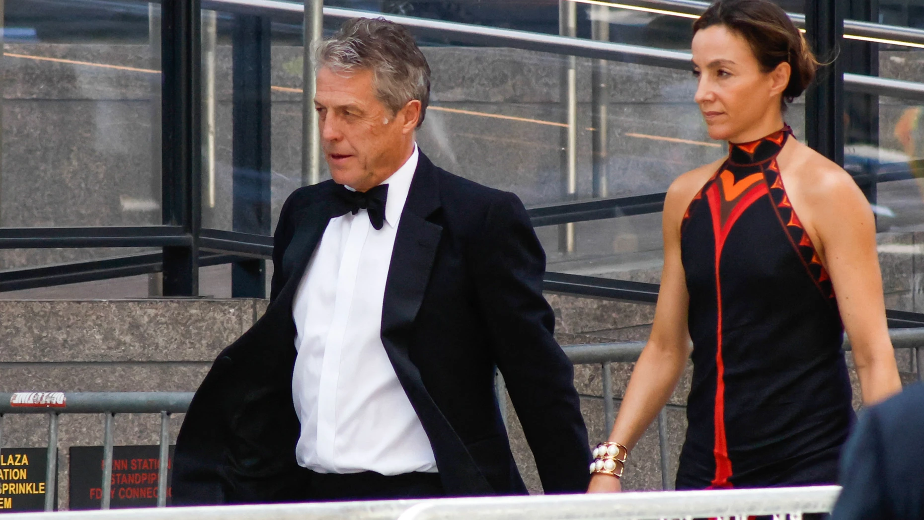 British actor Hugh Grant and Swedish producer Anna Elisabet Eberstein arrive at Madison Square Garden, the reported venue for the wedding celebrations of pop singer Taylor Swift and pro-athlete Travis Kelce, in New York City on July 3, 2026. Swift and Kelce's official wedding plans are tightly under wraps, but New York is bracing to host the celebrity marriage of the year this week at Madison Square Garden. The wedding will reportedly take place Friday with a star-studded guest list of around 1,000, including models Gigi Hadid and Cara Delevingne, singer Selena Gomez, and actress Zoe Kravitz -- all known to be close Swift pals -- and Kelce's Kansas City Chiefs teammates. (Photo by kena betancur / AFP)