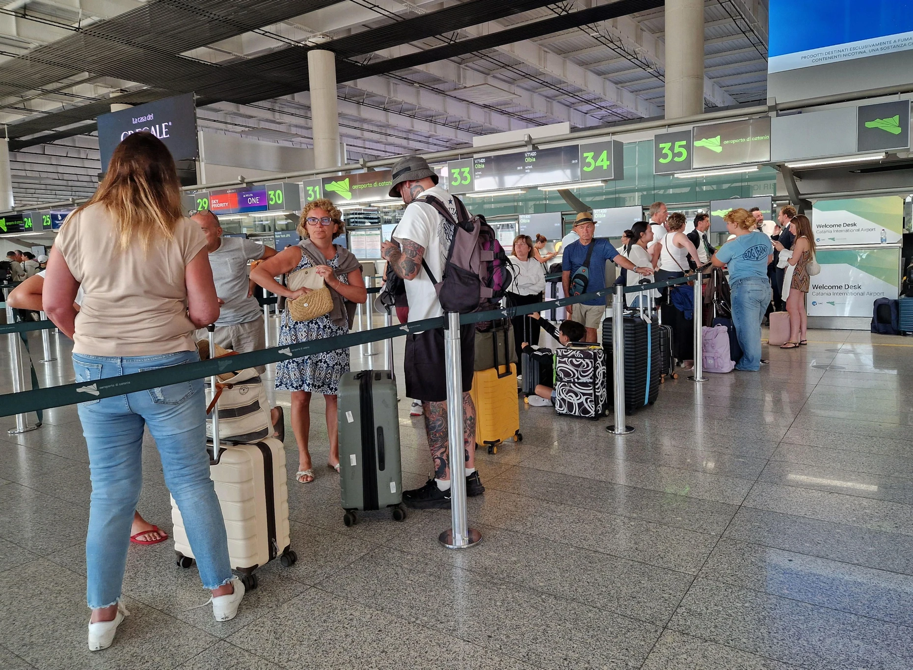 Waiting for information: Passengers at Catania Airport.