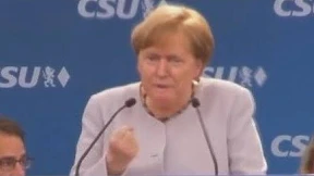 Merkel mit Trumps Gesicht