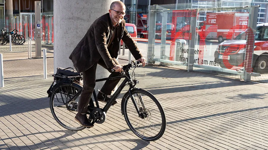 Stefan Majer mit Fahrrad vor der Feuerwehrzentrale in Frankfurt,