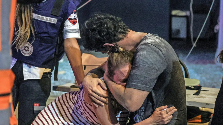 Trauer, Wut und Hoffnungslosigkeit: Menschen liegen sich weinend in den Armen, nachdem in Tel Aviv eine Rakete aus Gaza eingeschlagen ist.