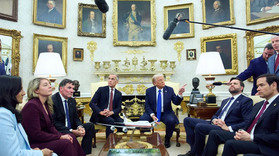 President Donald Trump meets with Canadian Prime Minister Mark Carney in the Oval Office of the White House, Tuesday, Oct. 7, 2025, in Washington. From left, Carney, Trump, Vice President JD Vance, and Secretary of State Marco Rubio. (AP Photo/Evan Vucci)