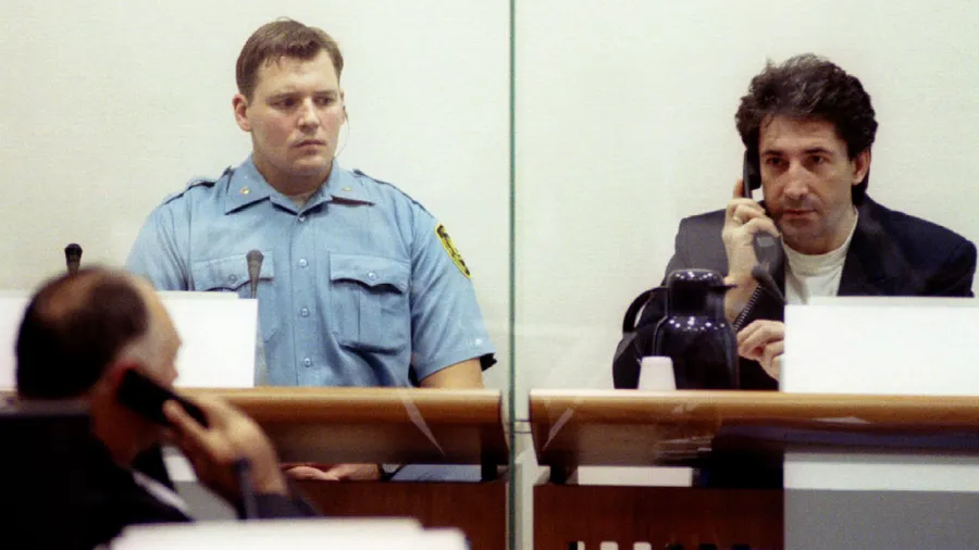 Bosnian Serb Dusko Tadic (R) who is accused for murder, torture and rape, pleaded not guilty to an amendedindictment that charges him with rounding up and mistreating prisoners in three instead of one Serb-run camp in Bosnia, consults his lawyer Mihaljo Vujin (L) during the Yugoslav war crimes tribunal session in The Hague, October 24