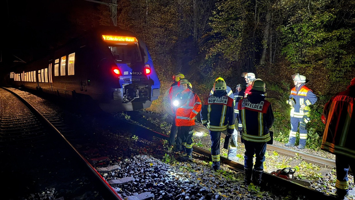 Feuerwehrleute arbeiten auf der Bahnstrecke Saarbrücken – Frankfurt an einem umgestürzten Baum.